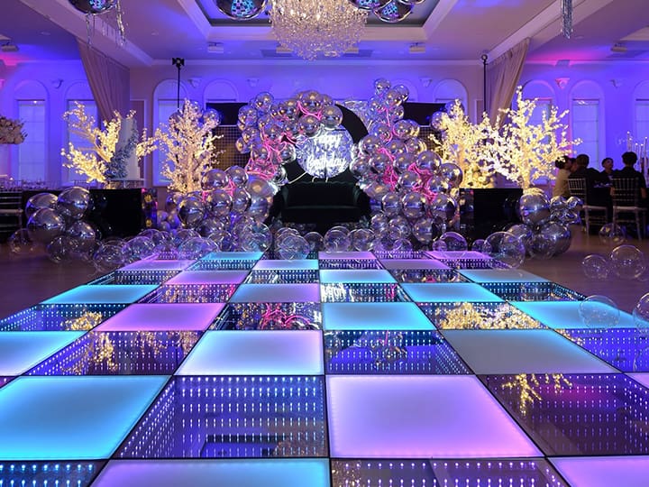 Illuminated LED dance floor glowing blue and purple at a birthday celebration