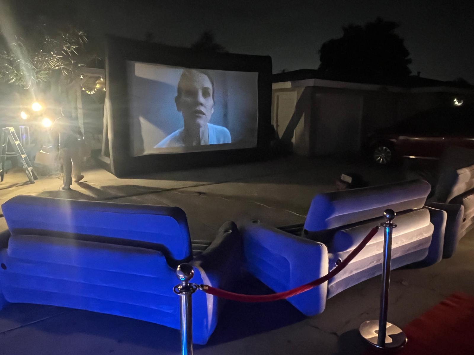 Backyard cinema with inflatable couches at night in Los Angeles